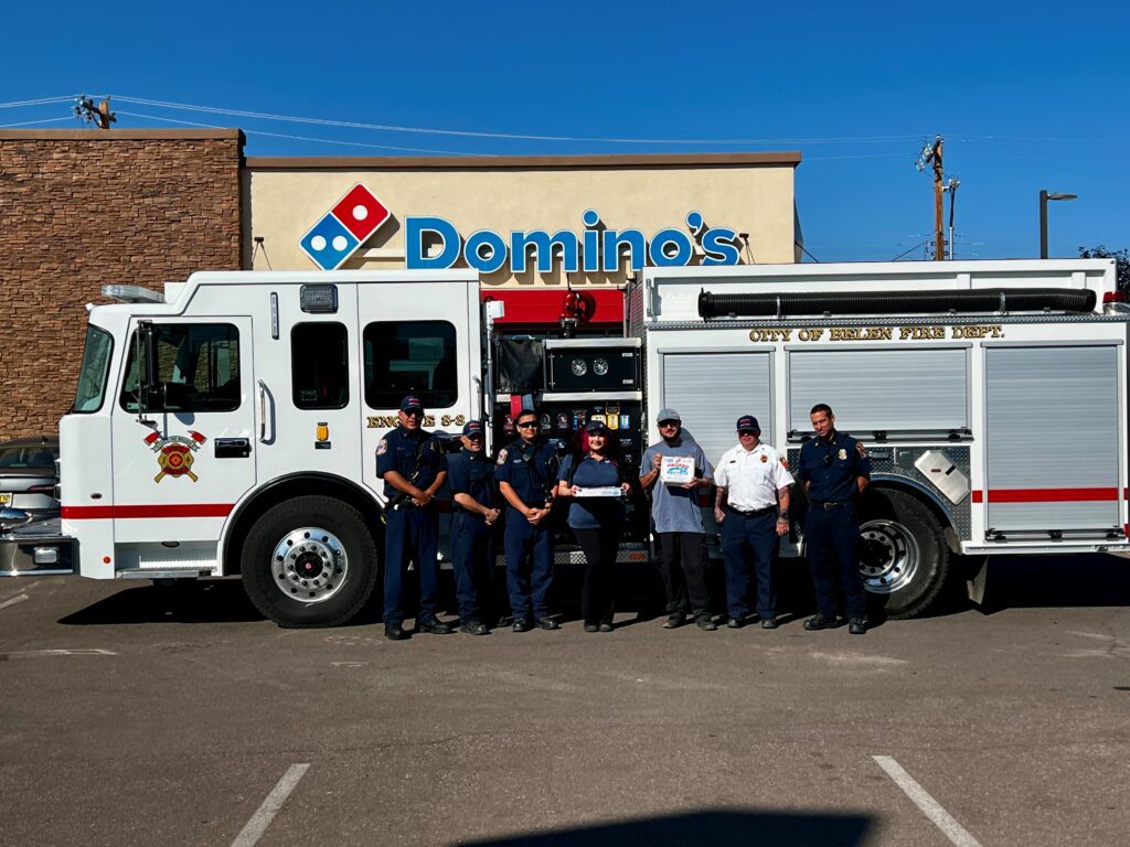 The Domino's team and the Belen Fire Department on October 9th delivering pizza AND safety to Belen households.